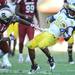 Michigan senior quarterback Denard Robinson skirts Souht Carolina's D.J. Swearinger during the second half of the Outback Bowl at Raymond James Stadium in Tampa, Fla. on Tuesday, Jan. 1. Melanie Maxwell I AnnArbor.com
